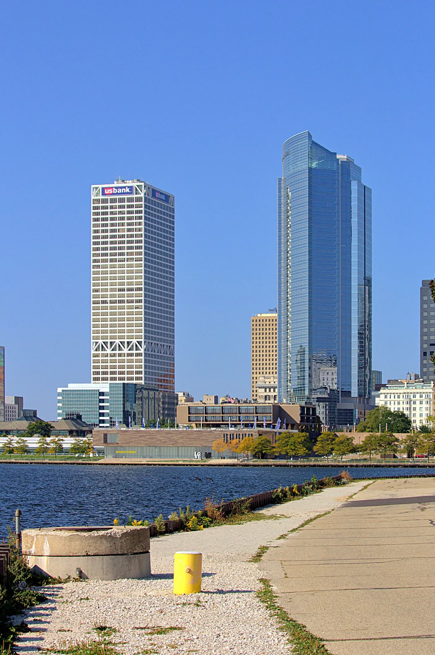 Downtown Milwaukee’s towers rising beyond the Lake Michigan shoreline path on a clear day.