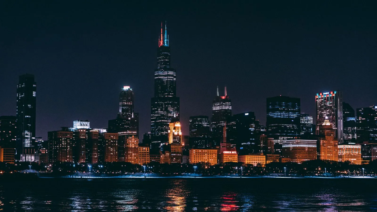Chicago’s skyline lit up at night across the water.